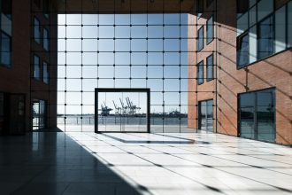 Modern building with glass facade overlooking a harbor