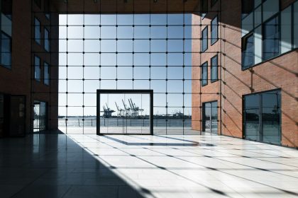 Modern building with glass facade overlooking a harbor